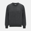 View 1 of product The Turnbull & Asser Charcoal Grey Cashmere Round Neck Jumper features a crew neck, long sleeves, and ribbed cuffs, collar, and hem—an essential piece of men’s knitwear displayed on a white background.