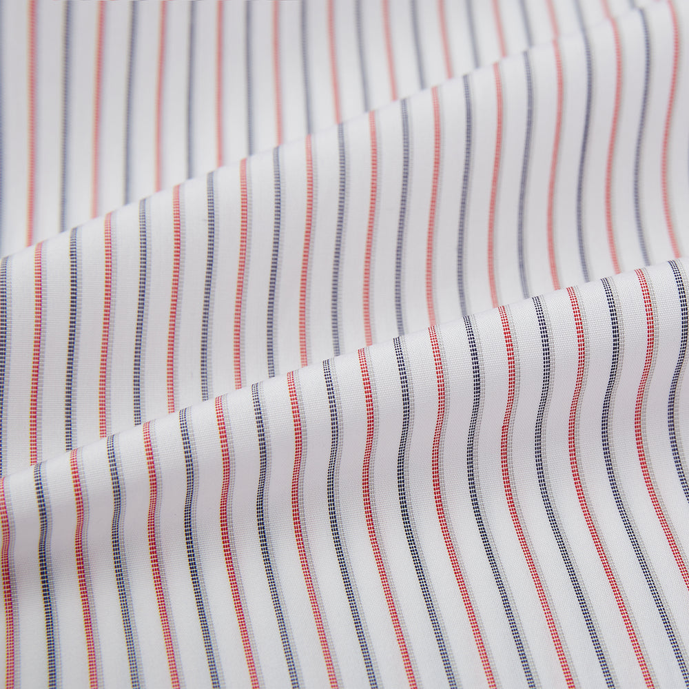 The Turnbull & Asser Red and Blue Double Stripe Westminster Shirt is a long-sleeved, button-up dress shirt with a formal collar, featuring narrow red and blue stripes on white, shown against a plain white background.