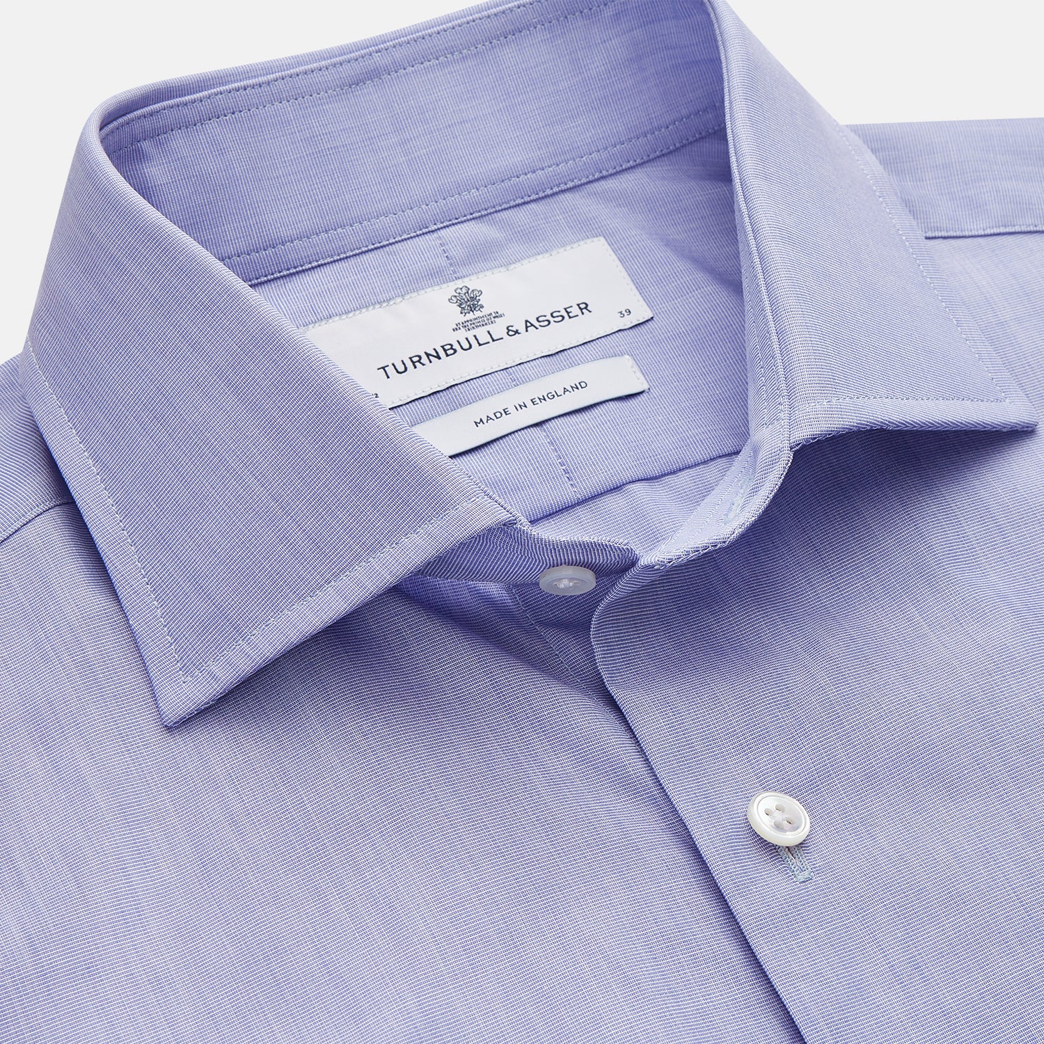 View 2 of product The Turnbull & Asser Tailored Fit Blue End-on-End Cotton Shirt features a Kent collar, double cuffs, and sleek white buttons—an ideal match for a navy suit to complete a sophisticated look. Displayed on a white background.