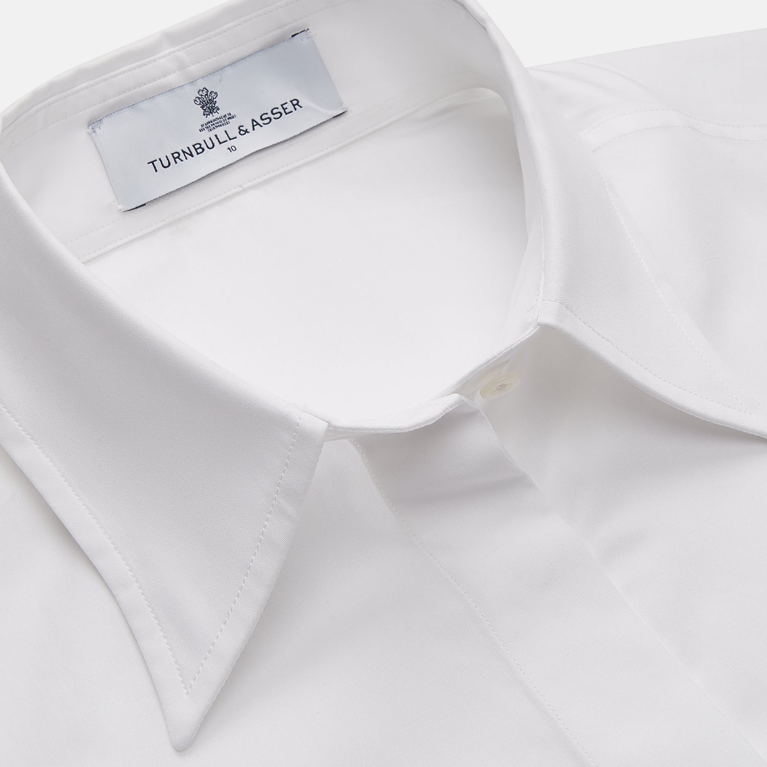 View 2 of product The White Cotton Tailored Bianca Shirt by Turnbull & Asser features a pointed collar and button cuffs, crafted from soft organic cotton and displayed flat on a white background for timeless elegance.