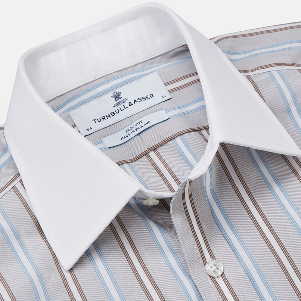 Turnbull & Asser's Beige Multi Stripe Cotton Regular Fit Penrose Shirt features blue, beige, and white vertical stripes with a crisp white collar and cuffs. Displayed on a plain background.