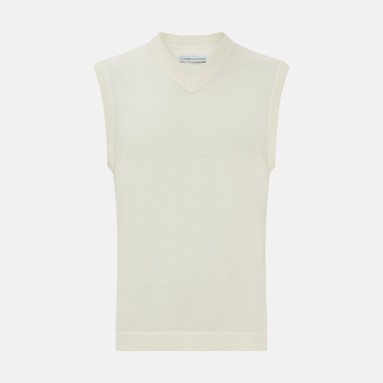 View 1 of product The Ecru Fine Merino V-Neck Vest by Turnbull & Asser is a sleeveless gentleman’s sweater with ribbed edges in cream knit, shown against a plain white background.