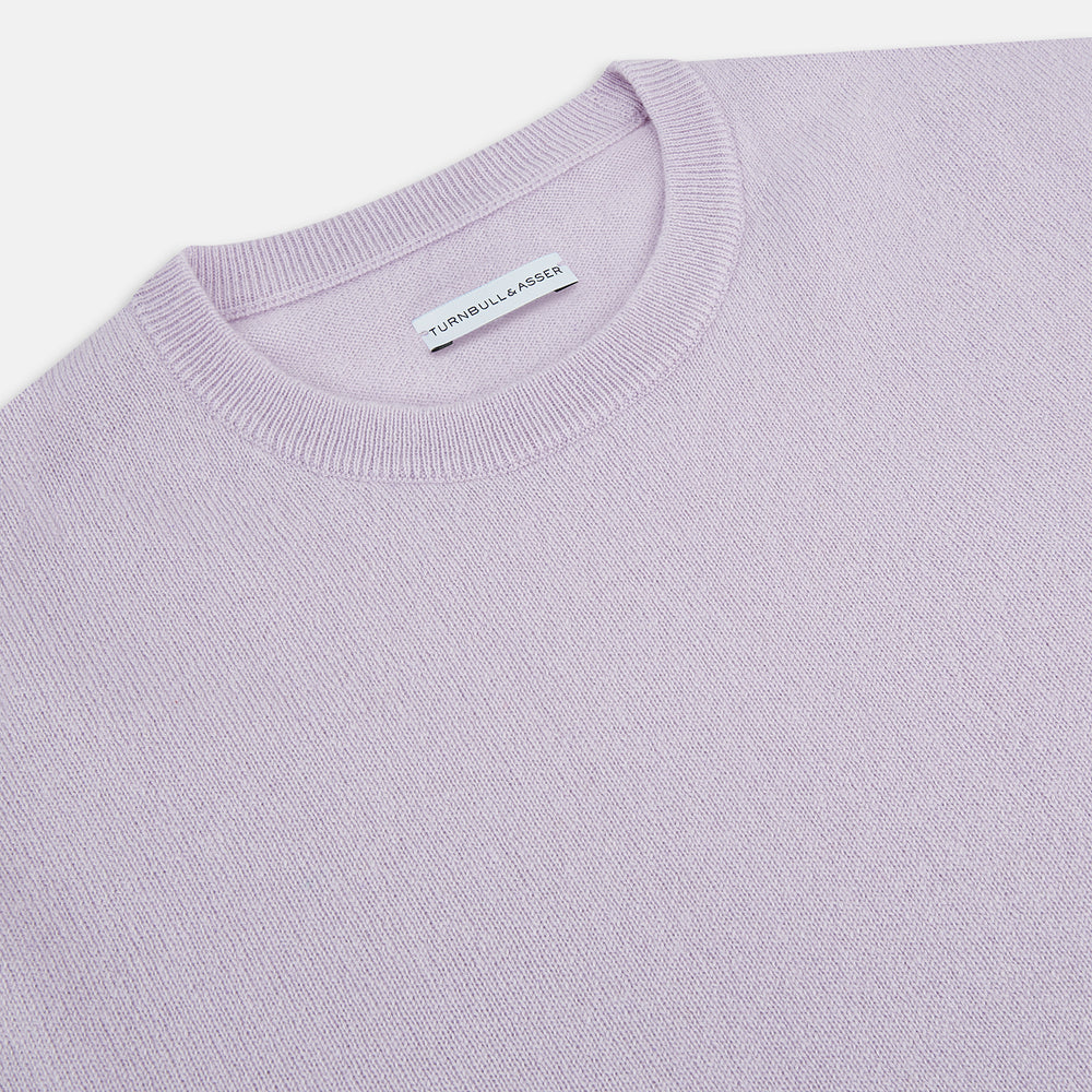 The Turnbull & Asser Lilac Cashmere Round Neck Jumper for men features long sleeves with ribbed cuffs and hem, offering a stylish, refined look. Shown against a white background.