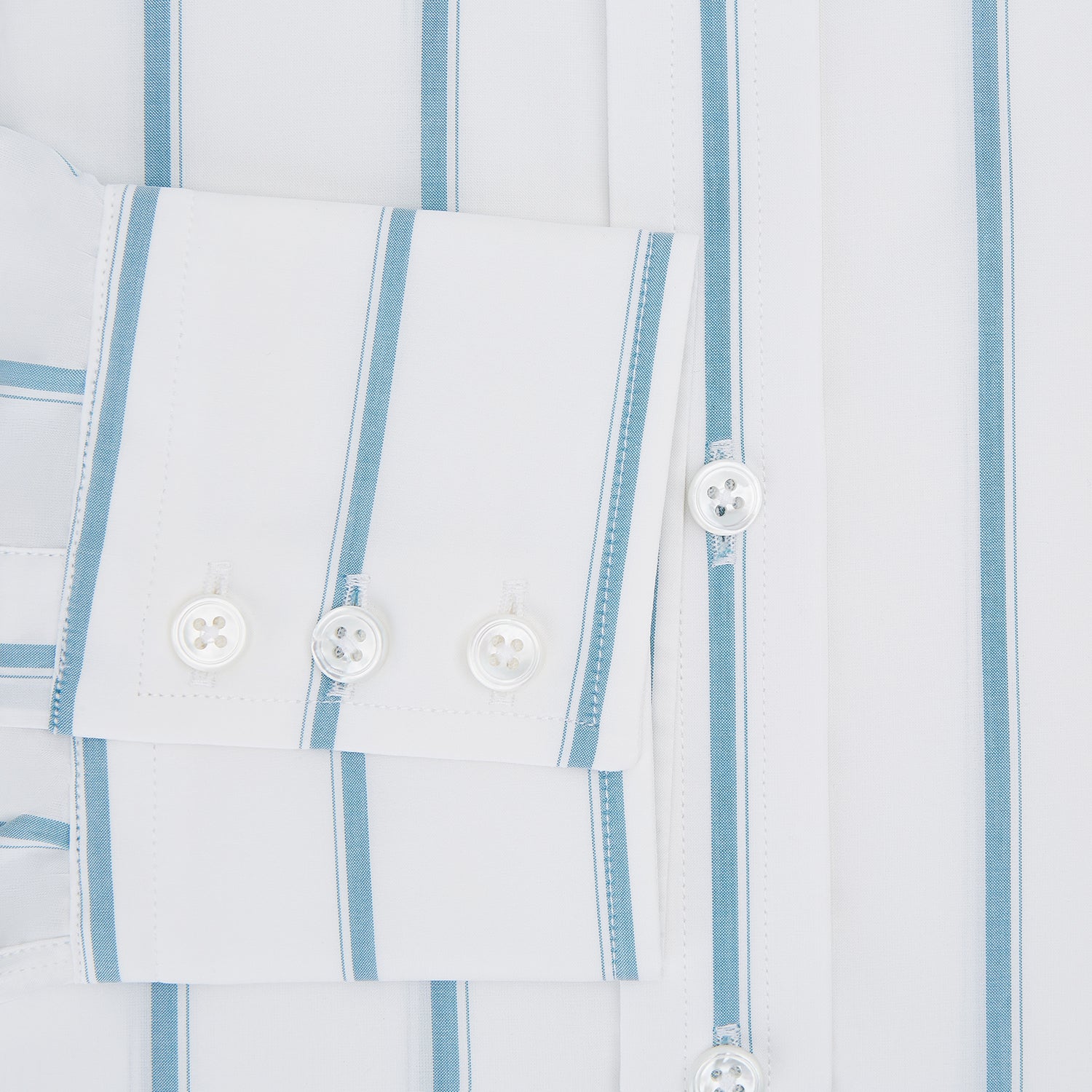 View 4 of product The Turnbull & Asser Turquoise Track Stripe Mayfair Shirt is crafted from Italian cotton with long sleeves, turquoise vertical stripes, a classic collar, and buttoned cuffs, displayed on a plain white background.