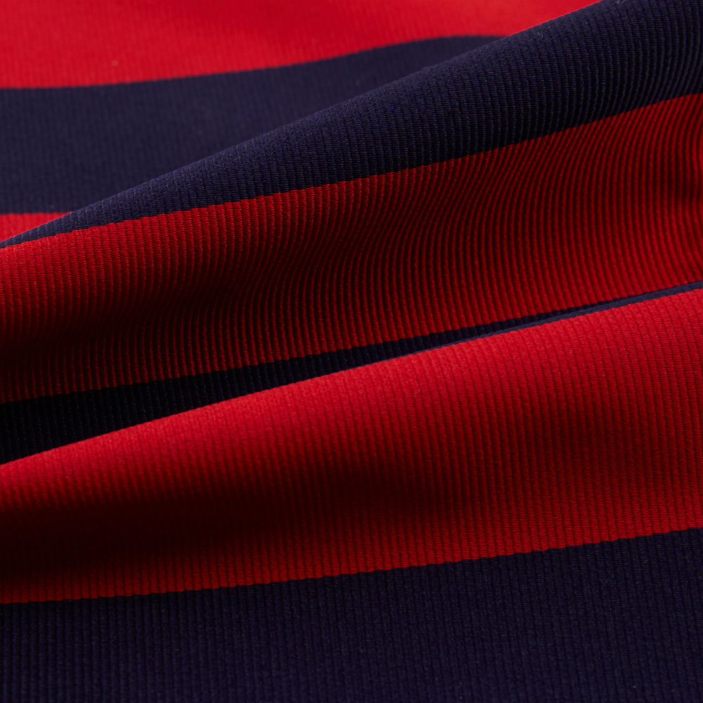 The Turnbull & Asser Wide Red Stripe and Navy Silk Cravat features bold diagonal stripes, adding a refined touch of British elegance to any ensemble.