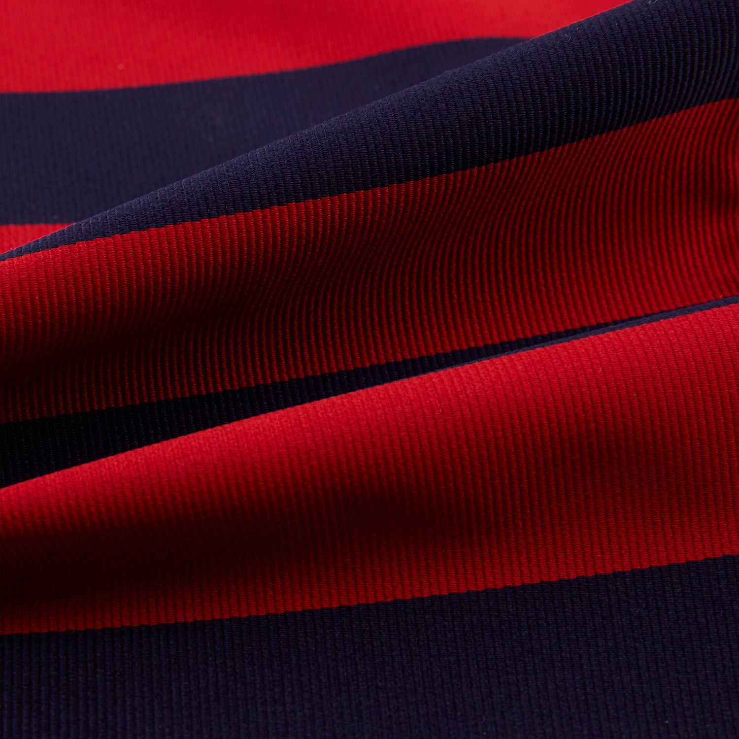 View 4 of product The Turnbull & Asser Wide Red Stripe and Navy Silk Cravat features bold diagonal stripes, adding a refined touch of British elegance to any ensemble.