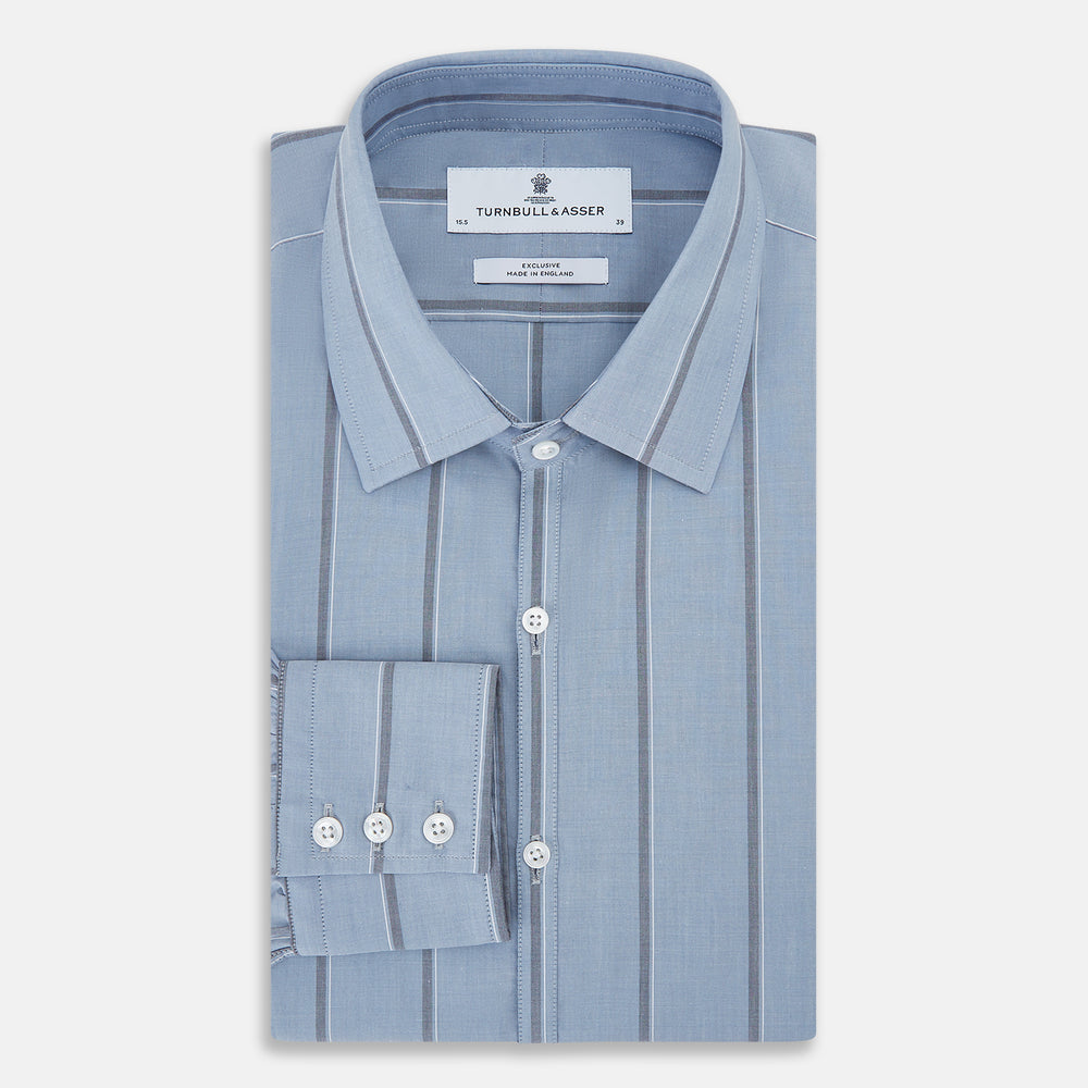 The Steel Blue Track Stripe Westminster Shirt by Turnbull & Asser features dark pinstripes, a classic collar, white buttons, and buttoned cuffs—expertly crafted to highlight British craftsmanship. Laid flat on white background.