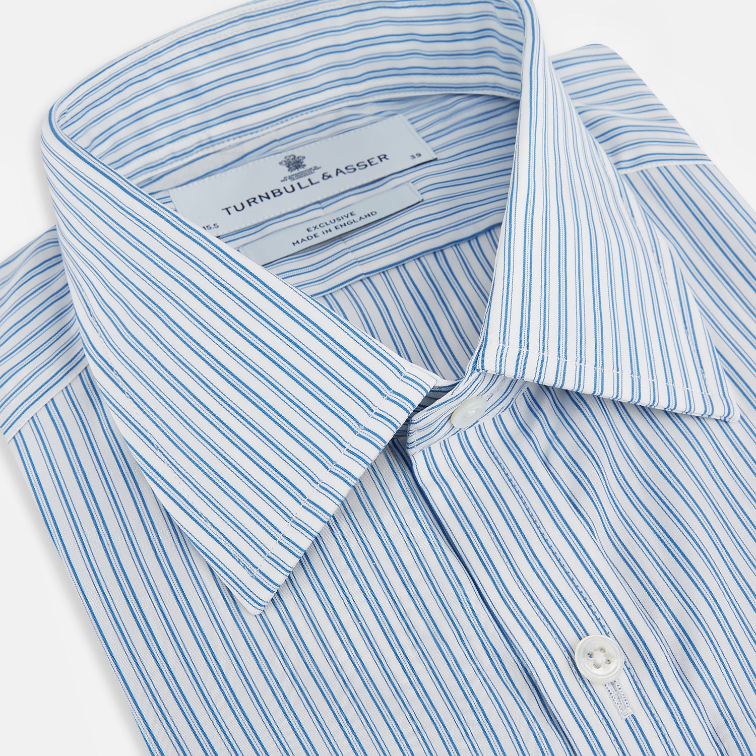 View 2 of product The Turnbull & Asser Sky Blue Double Stripe Mayfair Shirt features sky blue and white vertical stripes, a T&A collar, buttoned cuffs, and is displayed flat on a white background.