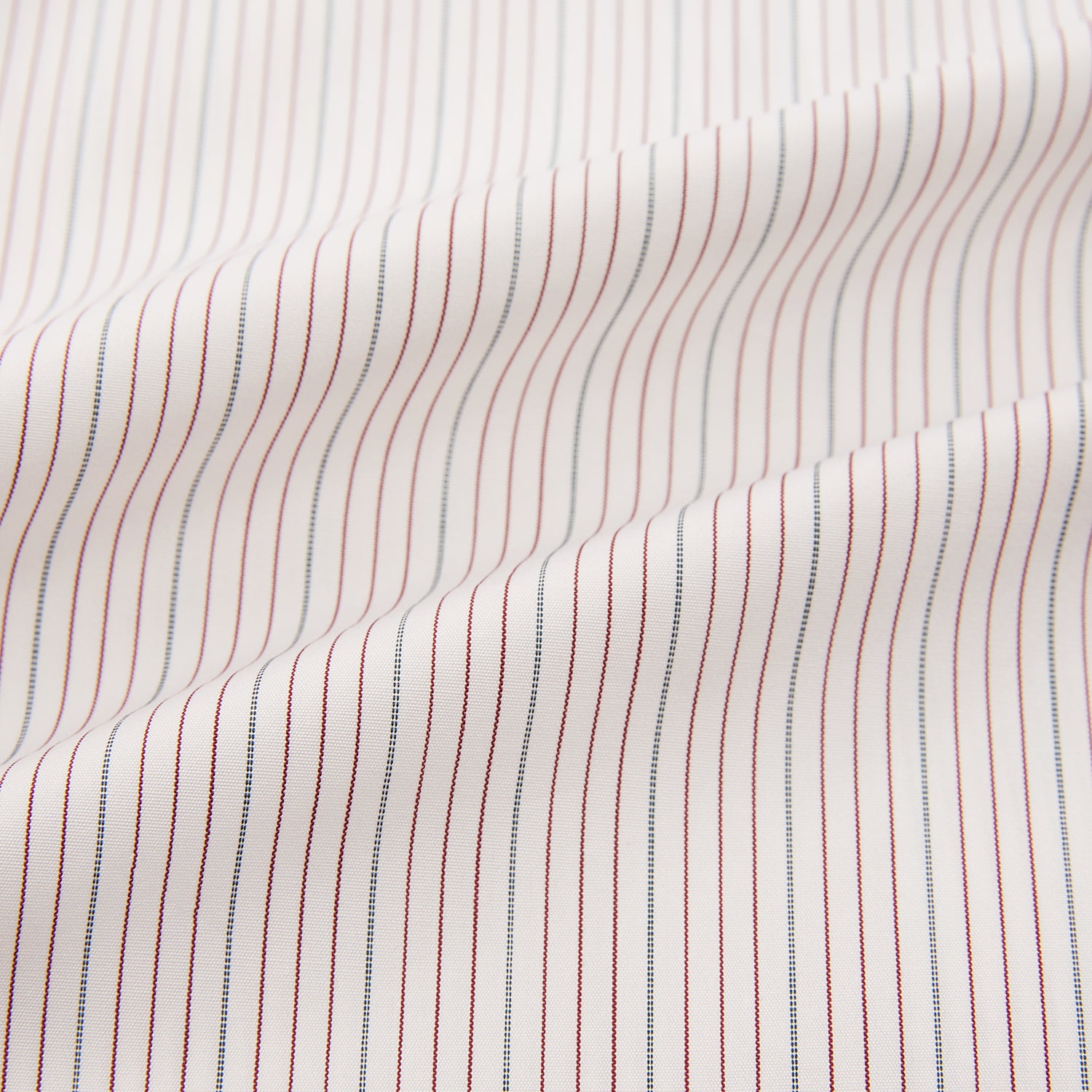View 6 of product The Turnbull & Asser Burgundy Multi Hairline Stripe Mayfair Shirt features long sleeves, a classic collar, buttoned cuffs, and slim vertical stripes—ideal for formal wear and shown against a plain white background.
