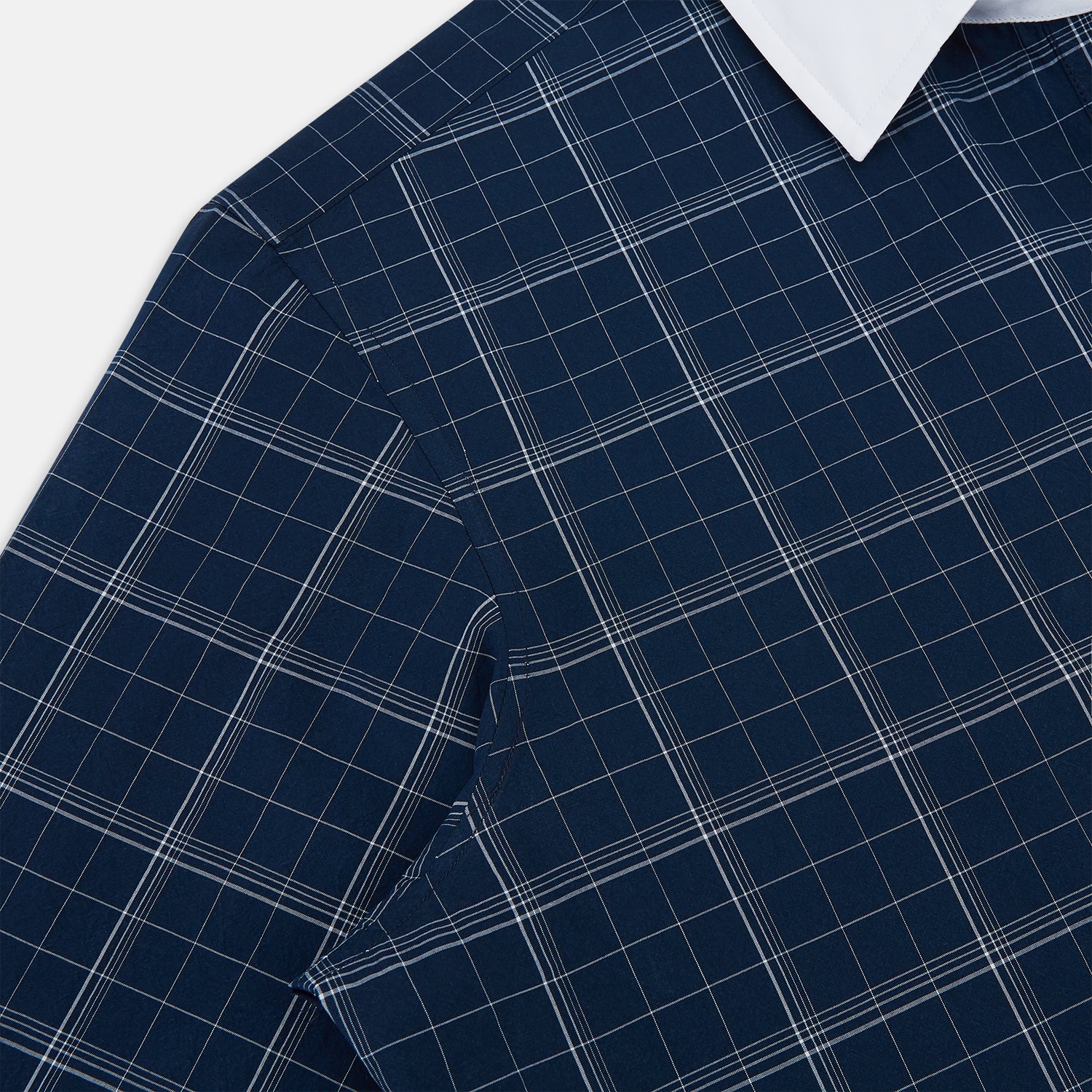 View 6 of product The Turnbull & Asser Indigo Windowpane Check Windsor Shirt features a contrast T&A collar and cuffs, highlighting British craftsmanship. It is displayed flat on a white background.