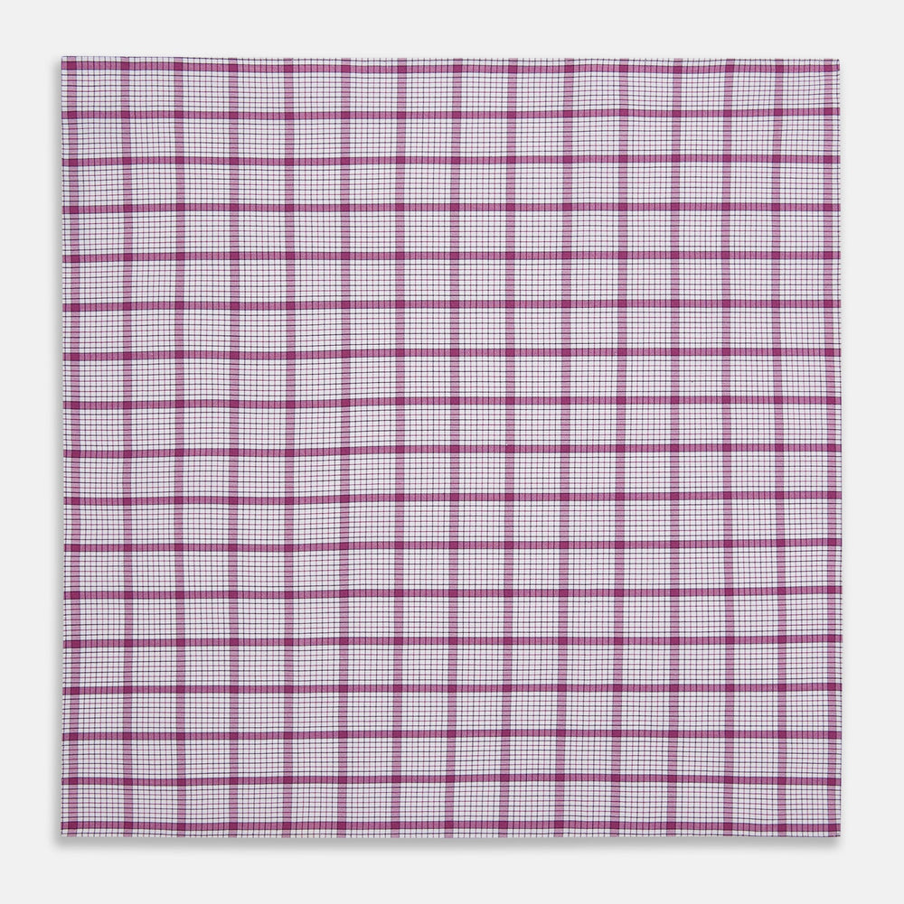 The Turnbull & Asser Hand Rolled Purple Graph Overlay Check Handkerchief is a white cotton accessory featuring intersecting purple and pink lines that create evenly spaced squares across the fabric.