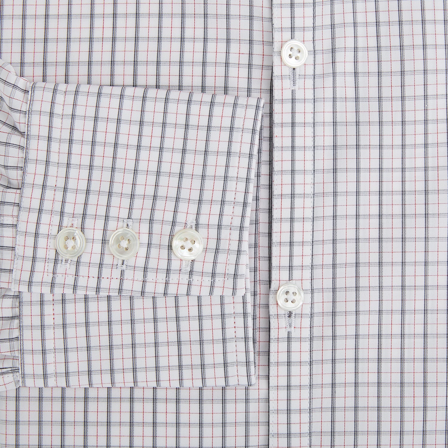 View 4 of product The Blue and Red Graph Check Westminster Shirt by Turnbull & Asser features a classic collar, long sleeves, and British craftsmanship, with a blue and red checkered pattern on white, displayed flat on a white surface.