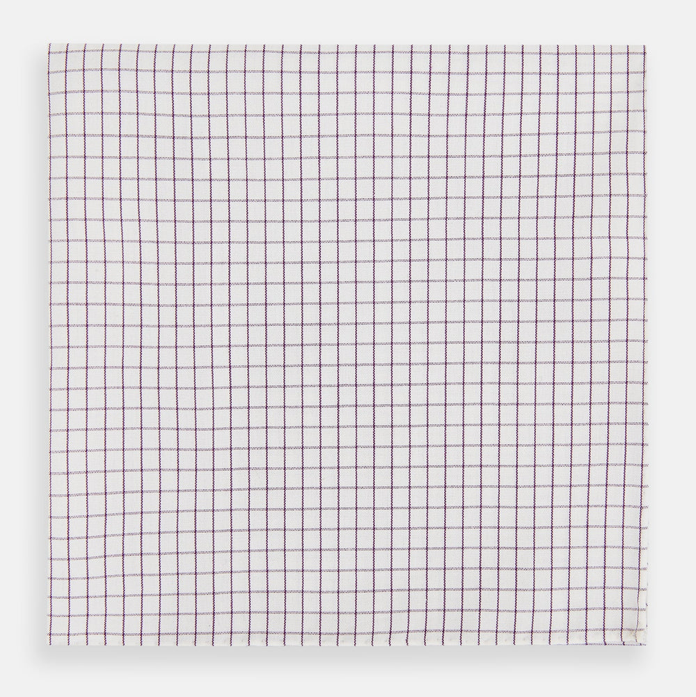 The Turnbull & Asser Hand Rolled Purple Graph Check Handkerchief features a white cloth with evenly spaced thin purple lines forming small squares, neatly laid flat against a white background.
