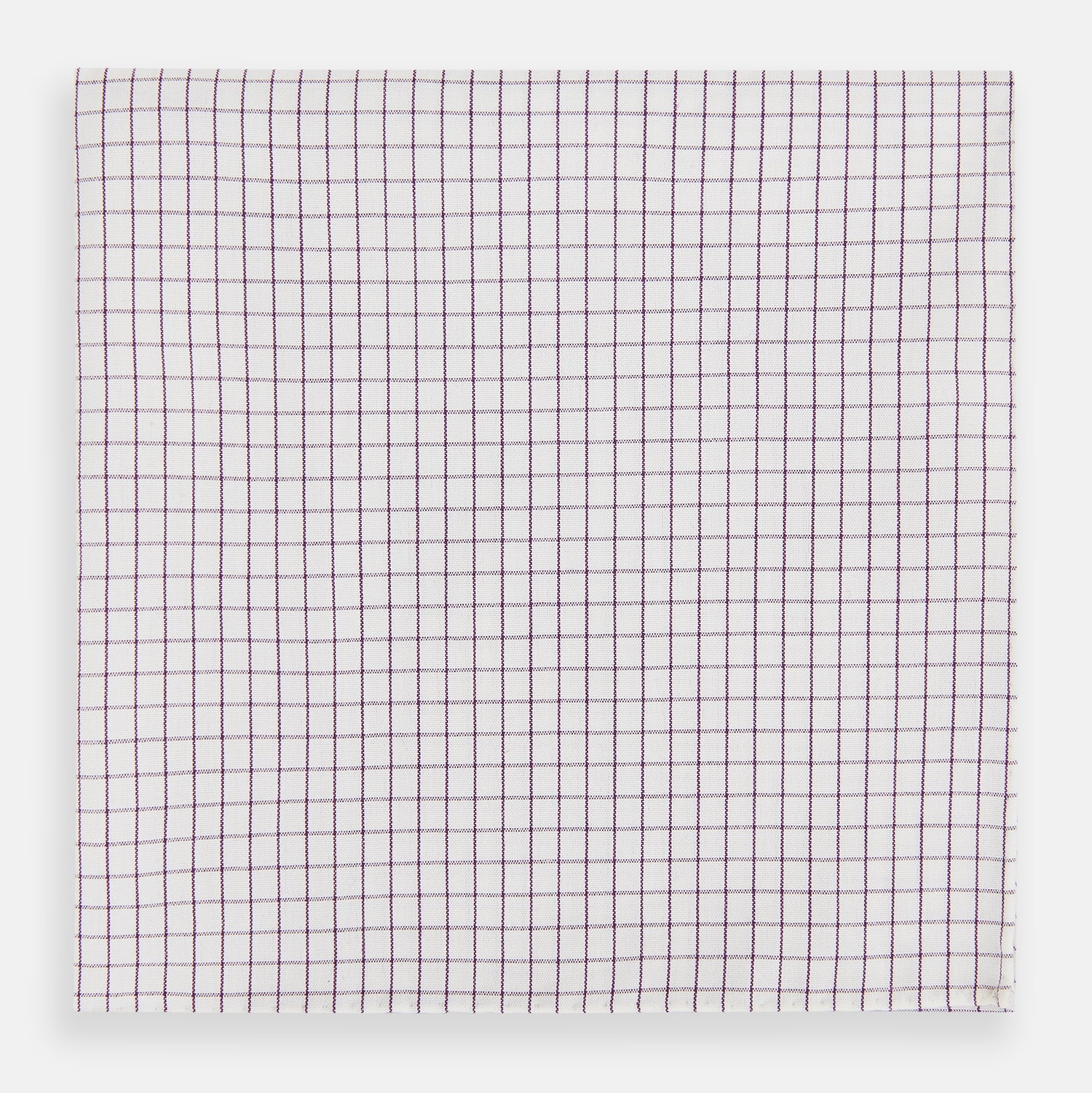 View 1 of product The Turnbull & Asser Hand Rolled Purple Graph Check Handkerchief features a white cloth with evenly spaced thin purple lines forming small squares, neatly laid flat against a white background.