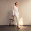 View 12 of product The White Cotton Lauren Shirt by Turnbull & Asser, featuring a stand collar, button-down front, and elongated body, is laid flat on a plain white background.