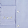 View 4 of product The Turnbull & Asser BLUE HERRINGBONE TAILORED FIT SHIRT WITH KENT COLLAR features long sleeves and buttoned cuffs, offering a timeless formal look in a classic light blue herringbone fabric, laid flat on a white background.