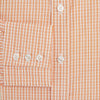 View 4 of product The Turnbull & Asser Orange Micro Check Mayfair Shirt, a long-sleeve button-up with a classic T&A collar and white-orange micro check pattern, is shown neatly laid flat on a white background.