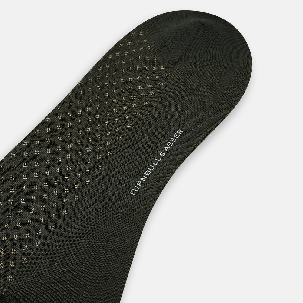 A single forest green mid-length sock from Turnbull & Asser, featuring a motif pattern and crafted from soft mercerised Egyptian cotton, shown against a plain white background.