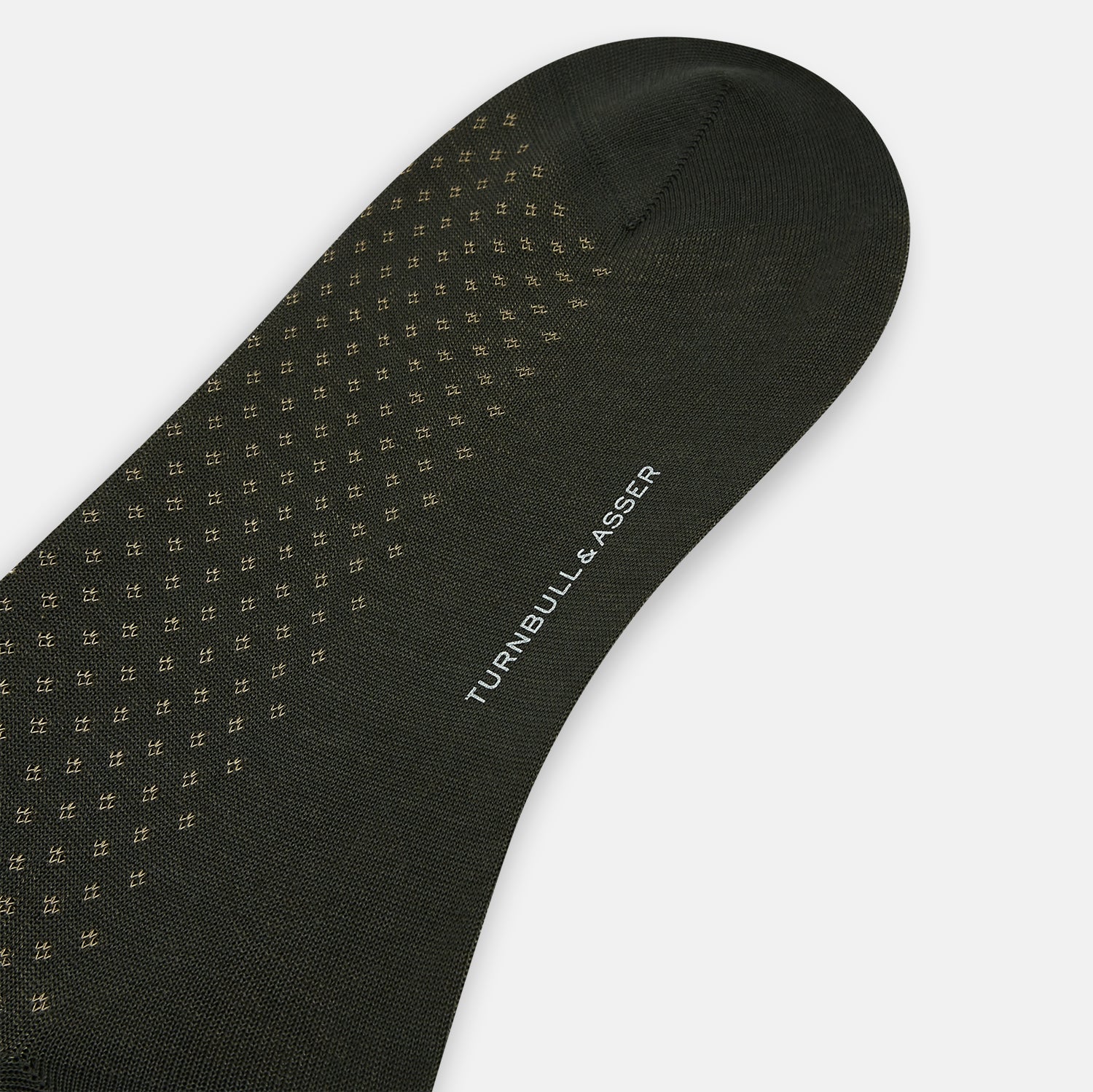 View 3 of product A single forest green mid-length sock from Turnbull & Asser, featuring a motif pattern and crafted from soft mercerised Egyptian cotton, shown against a plain white background.