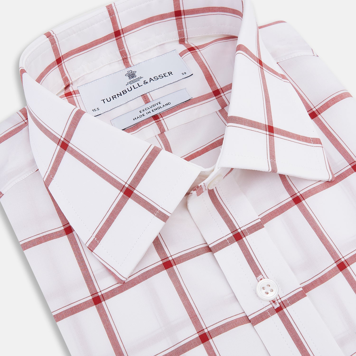 View 2 of product The Turnbull & Asser Dark Red Grid Check Mayfair Shirt is a long-sleeve white shirt made from Italian cotton, featuring a bold dark red grid pattern, button-down front, and classic collar, shown laid flat on a white background.