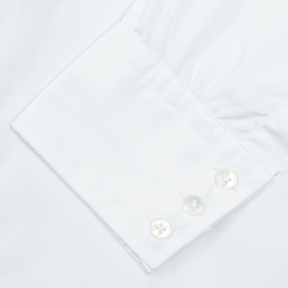 A neatly folded Turnbull & Asser Two-Fold 200 White Cotton Shirt with a Regent collar and 3-button cuffs, crafted from breathable fabric, is displayed on a light grey background with the label visible inside the collar.