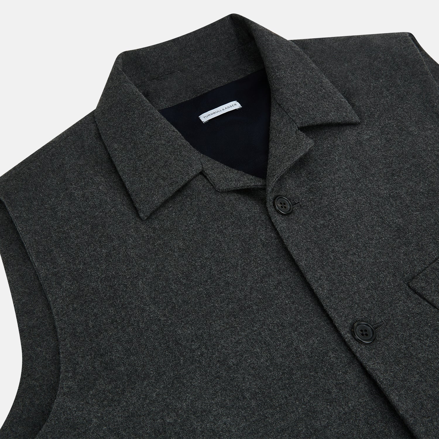 View 2 of product The Graphite Melange Collared Single-breasted Waistcoat by Turnbull & Asser features a dark gray hue, front buttons, collar, two zippered side pockets, and a chest pocket—perfect for winter. Shown on a plain white background.
