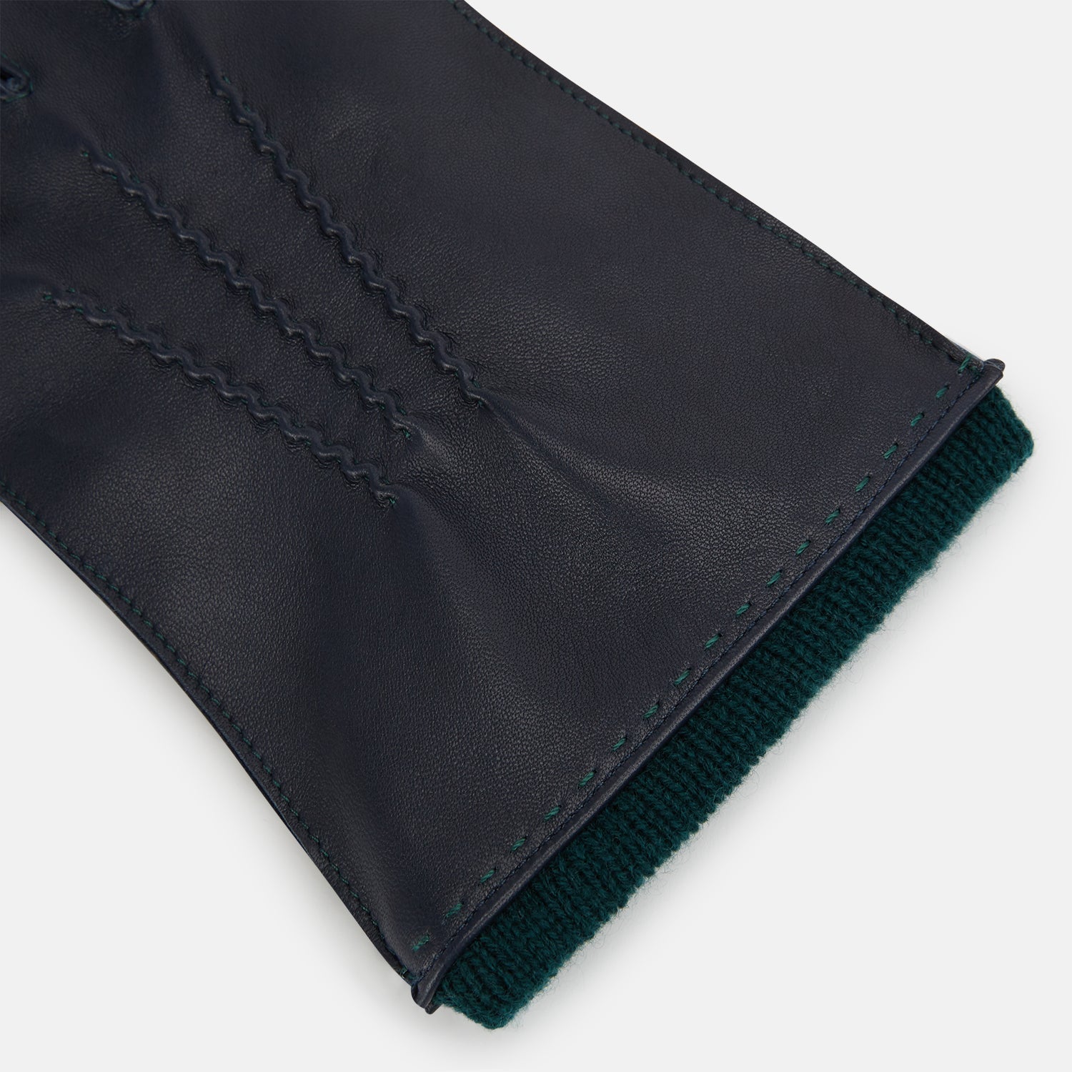 View 2 of product A pair of Turnbull & Asser Navy/Forest Green Cashmere-Lined Hairsheep Leather Gloves are shown flat, one palm up and one palm down, against a plain white background.