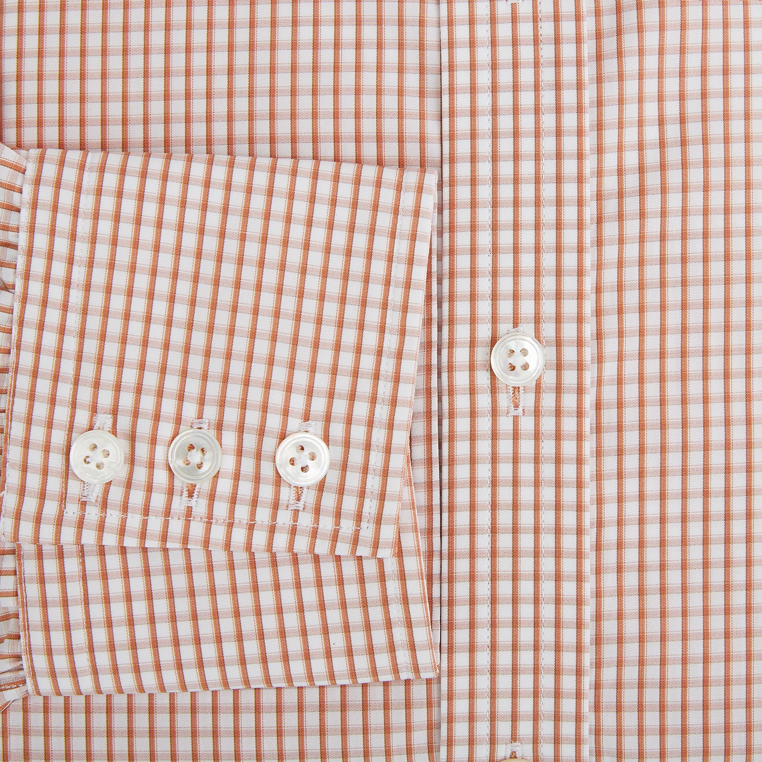 View 4 of product The Orange Micro Shadow Check Mayfair Shirt by Turnbull & Asser features a T&A collar, button-down front, and buttoned cuffs; crafted from Italian cotton in an orange and white check pattern, laid flat on a white background.