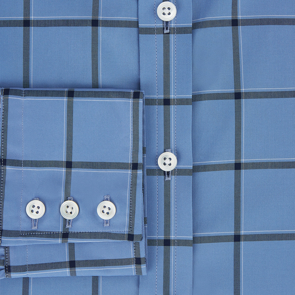 The Turnbull & Asser Colony Blue Grid Check Mayfair Shirt is a light blue, long-sleeve button-up with a collar and evenly spaced dark blue grid lines.