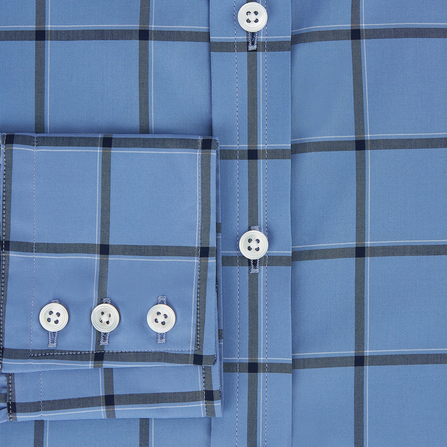 View 4 of product The Turnbull & Asser Colony Blue Grid Check Mayfair Shirt is a light blue, long-sleeve button-up with a collar and evenly spaced dark blue grid lines.