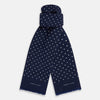 View 1 of product The Navy and White Spotted Silk Scarf by Turnbull & Asser features white polka dots, a fringed edge, and the brand's name printed near the bottom on both sides. It is neatly folded at the top.