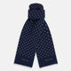 The Navy and White Spotted Silk Scarf by Turnbull & Asser features white polka dots, a fringed edge, and the brand's name printed near the bottom on both sides. It is neatly folded at the top.
