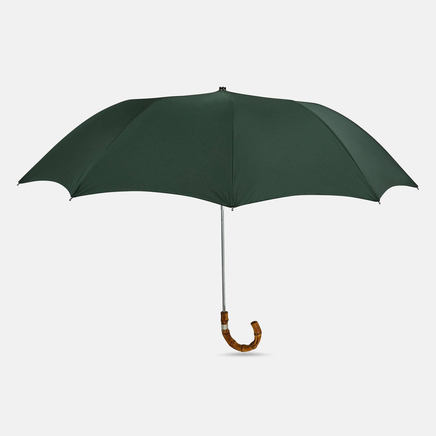 View 1 of product The Turnbull & Asser Forest Green Telescopic Umbrella with a whangee crook handle is opened and displayed on a plain white background, highlighting its expert craftsmanship and timeless style.