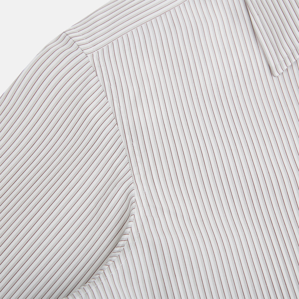 The Coffee and Grey Shadow Pinstripe Westminster Shirt by Turnbull & Asser features thin white and gray stripes, a long sleeve, button-down style, and signature collar, all reflecting classic British craftsmanship.