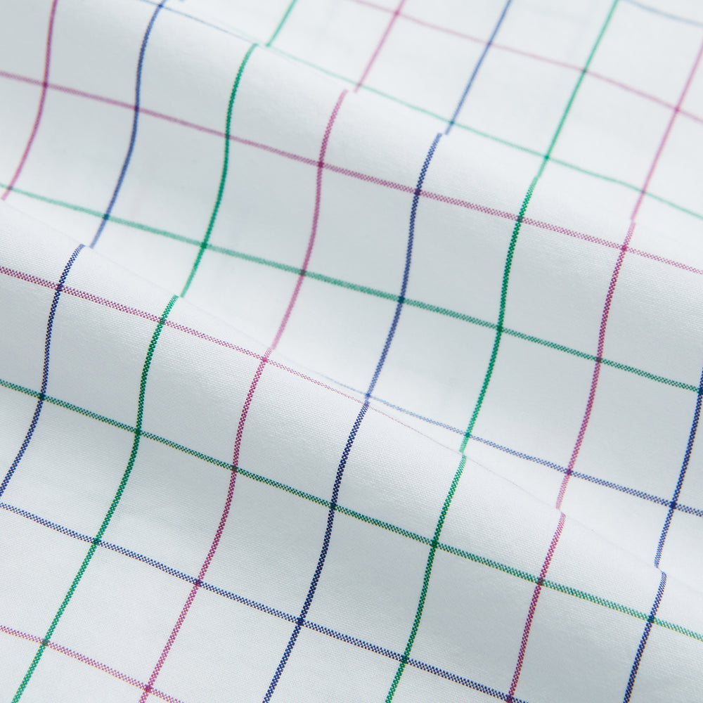 The Turnbull & Asser Pink Grid Check Mayfair Shirt is a long-sleeve, button-down shirt with a T&A collar, crafted from organic cotton and featuring a pink checkered grid pattern on white with buttoned cuffs.