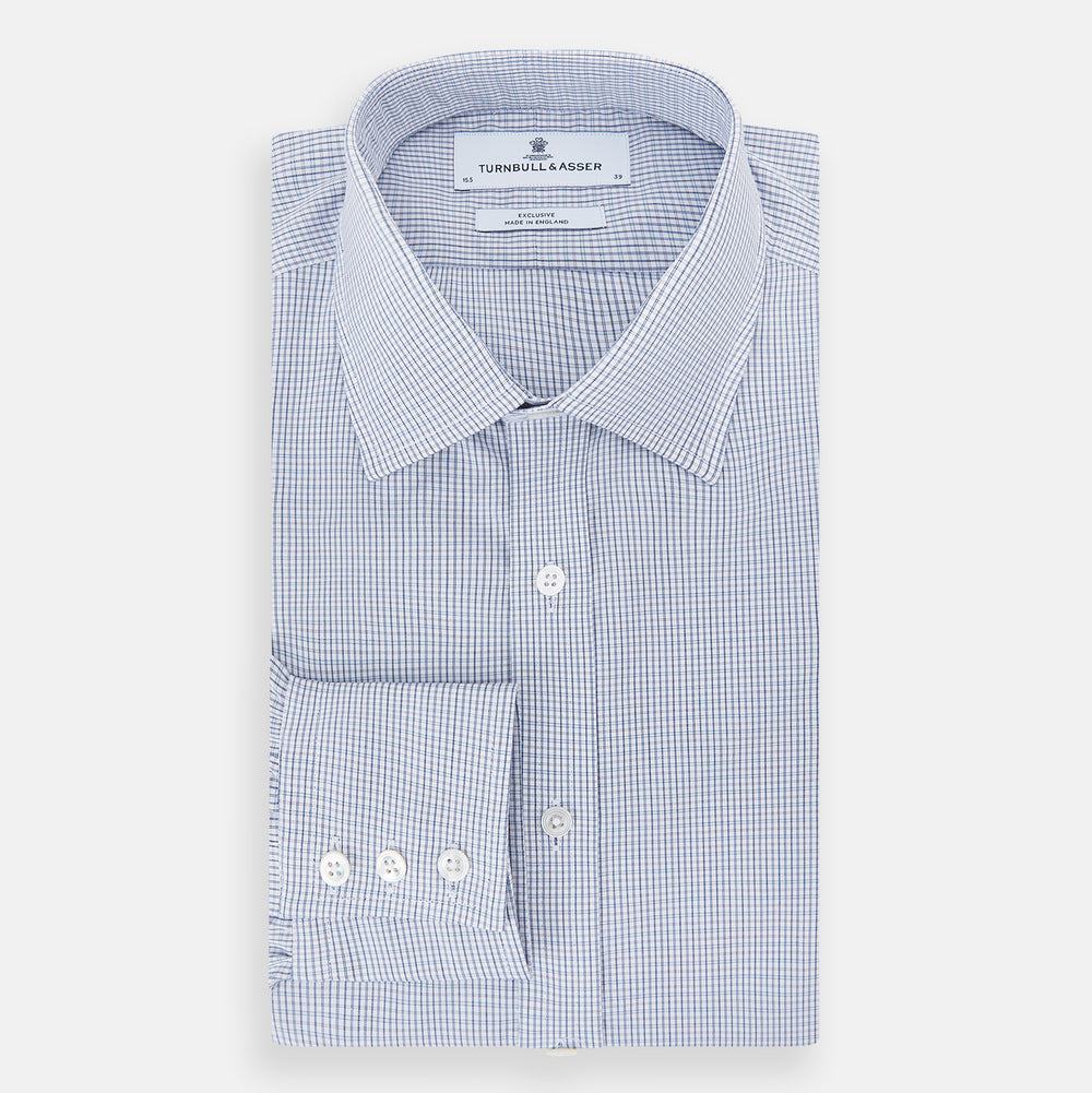 The Turnbull & Asser Blue Micro Graph Check Mayfair Shirt features long sleeves, a subtle check pattern, T&A collar, and buttoned cuffs, shown laid flat on a white background.