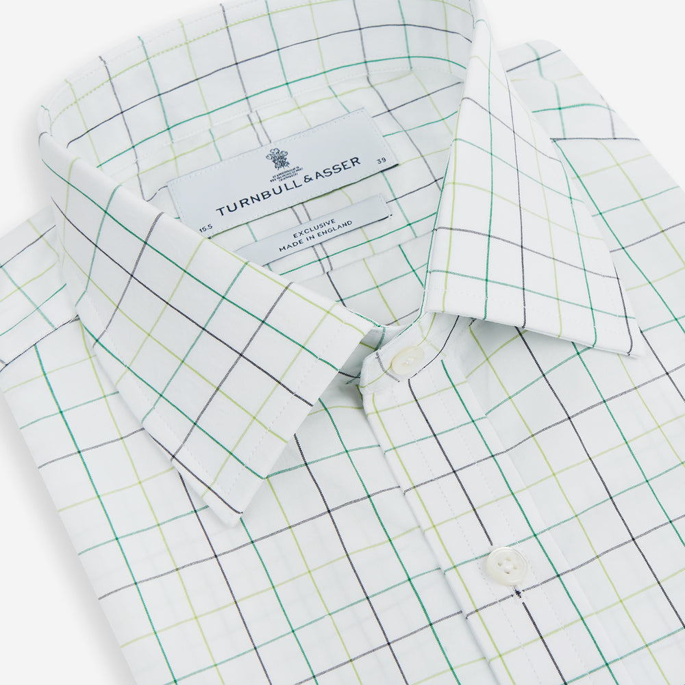 The Turnbull & Asser Dark Green Grid Check Mayfair Shirt features a white base with blue and dark green checks, a classic T&A collar, buttoned cuffs, and a Mayfair fit. The long-sleeve shirt is shown laid flat on a white background.