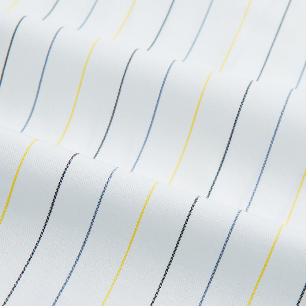 The Navy and Yellow Wide Pinstripe Mayfair Shirt by Turnbull & Asser is a long-sleeve, button-up shirt with wide navy and yellow pinstripes, a collar, and buttoned cuffs, laid flat on a white surface.