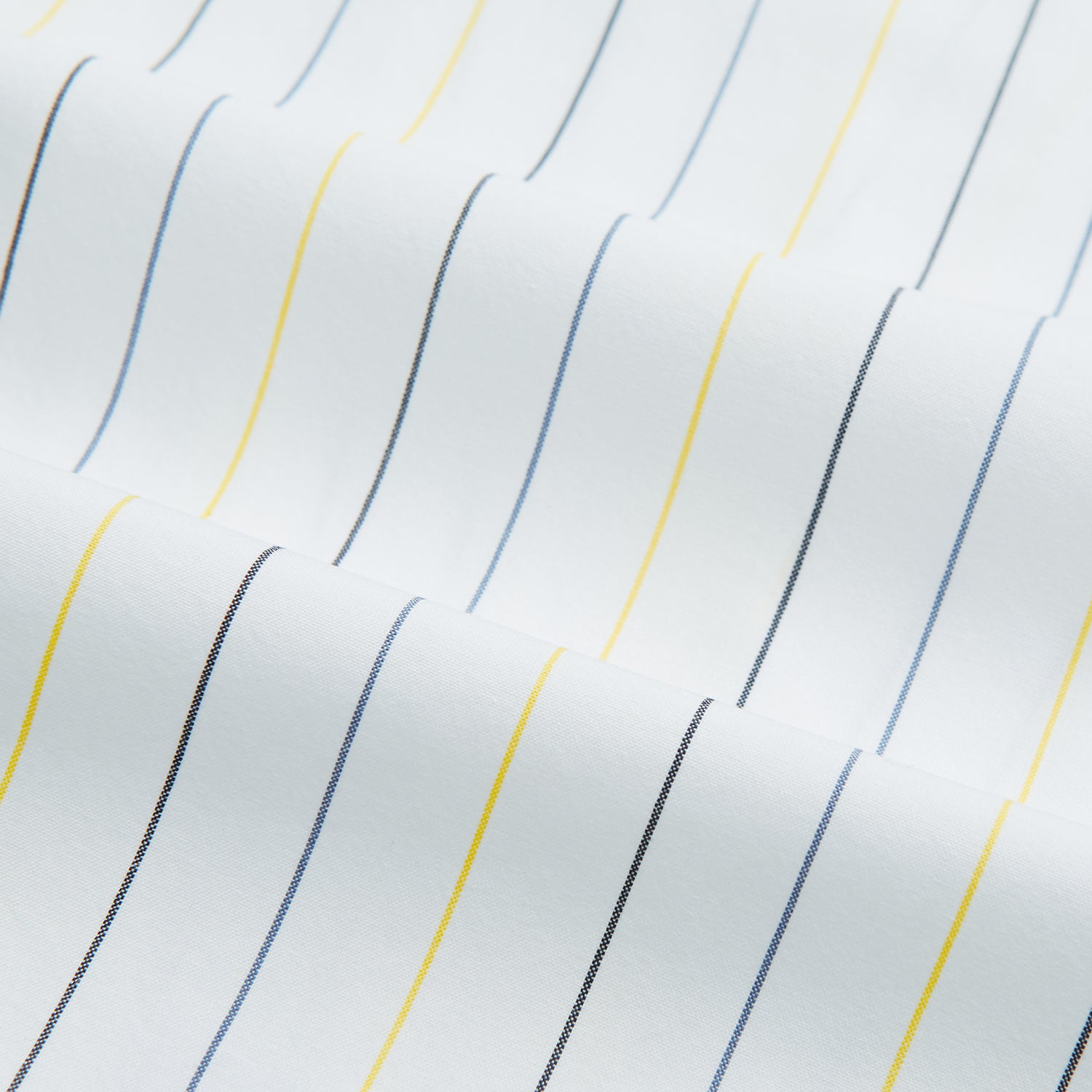 View 6 of product The Navy and Yellow Wide Pinstripe Mayfair Shirt by Turnbull & Asser is a long-sleeve, button-up shirt with wide navy and yellow pinstripes, a collar, and buttoned cuffs, laid flat on a white surface.