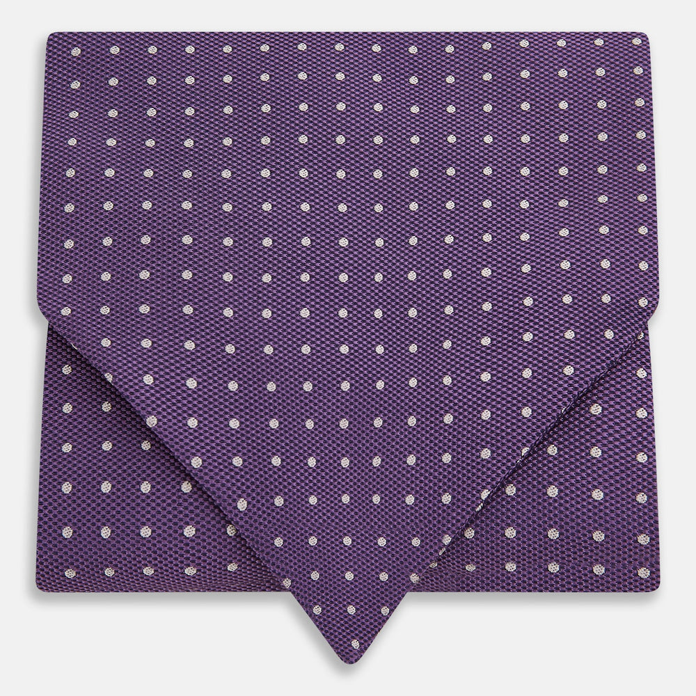 The Lilac and Purple Micro Dot Silk Cravat by Turnbull & Asser features evenly spaced white dots—offering an elegant, handmade accent to your formal ensemble or pocket square collection.