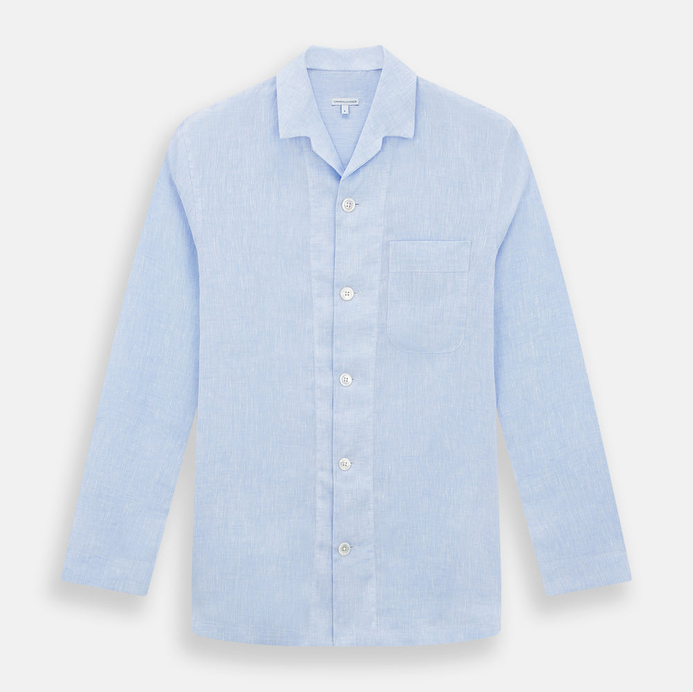 The Turnbull & Asser Pale Blue Linen Pyjama Shirt features long sleeves, a collar, front buttons, and a chest pocket—perfect as elegant loungewear or nightwear.