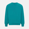View 3 of product The Turnbull & Asser Turquoise Fine Merino V-Neck Jumper features long sleeves, ribbed cuffs and waistband, shown on a white background—a timeless choice for classic knitwear enthusiasts.