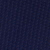 View 3 of product The Turnbull & Asser Seven-Fold Navy Lace Silk Tie is shown on a white background, rolled at one end with the pointed tip facing forward.