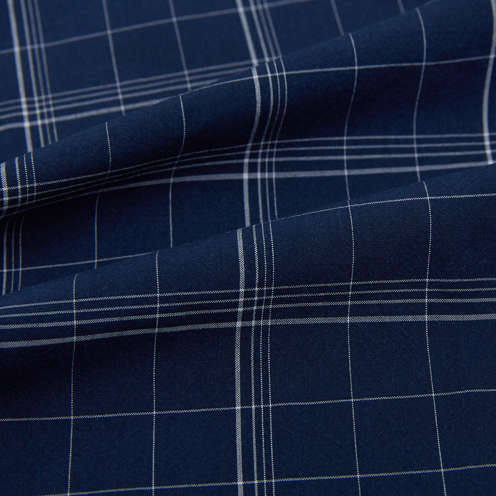 The Indigo and White Thin Plaid Check Windsor Shirt by Turnbull & Asser, a long-sleeve button-up with white buttons, is shown laid flat on a white background.