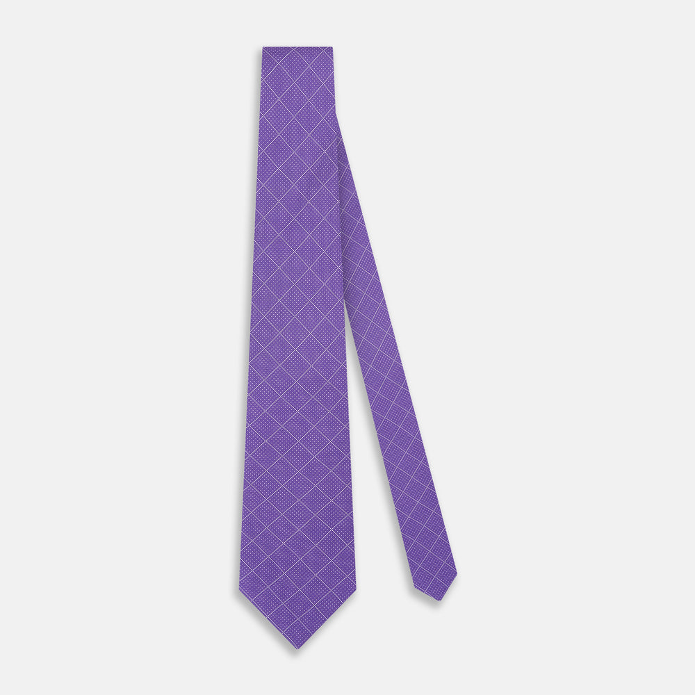 The Turnbull & Asser Purple Dotted Check Pattern Printed Silk Tie is displayed rolled up on a white background, featuring a subtle check design for an elegant look.
