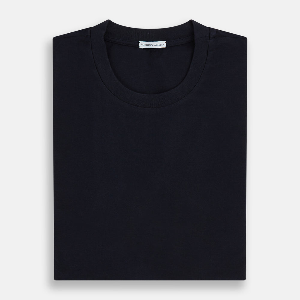 A navy short-sleeve pyjama shirt by Turnbull & Asser is laid flat on a white background, displaying the front view. Its soft fabric ensures comfort with no visible logos, designs, or patterns on the shirt.