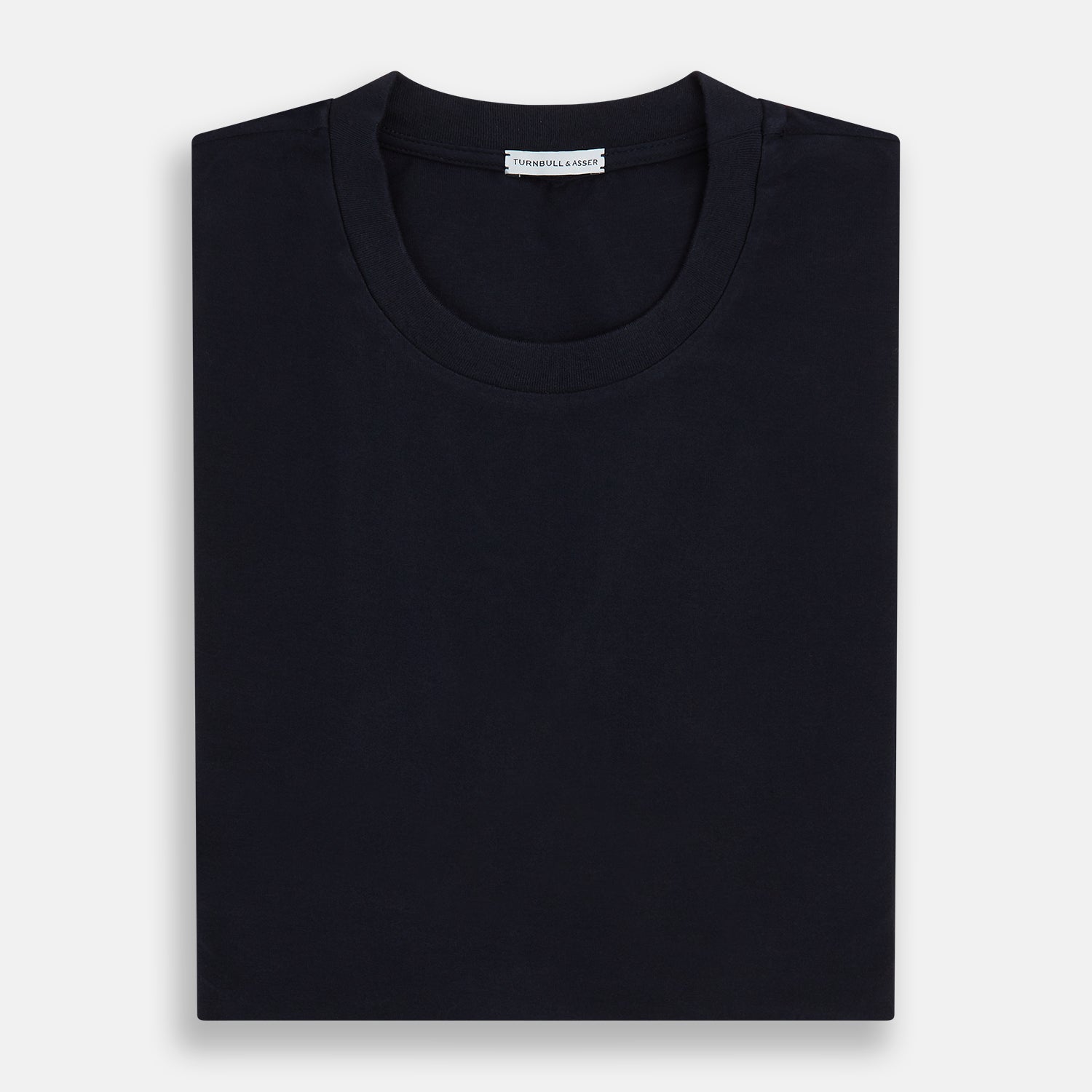 View 5 of product A navy short-sleeve pyjama shirt by Turnbull & Asser is laid flat on a white background, displaying the front view. Its soft fabric ensures comfort with no visible logos, designs, or patterns on the shirt.
