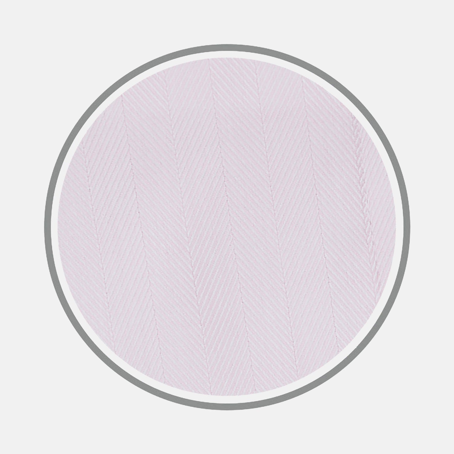 View 1 of product Close-up of Turnbull & Asser's Pink Herringbone Cotton Fabric, featuring a subtle herringbone pattern, displayed in a circular frame on a light gray background.