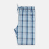 View 4 of product Turnbull & Asser Blue Multi Check Pyjama Trousers, featuring intersecting blue and white lines and a drawstring waistband, laid flat on a white background. Perfect to pair with your favorite cotton T-shirt for cozy comfort.