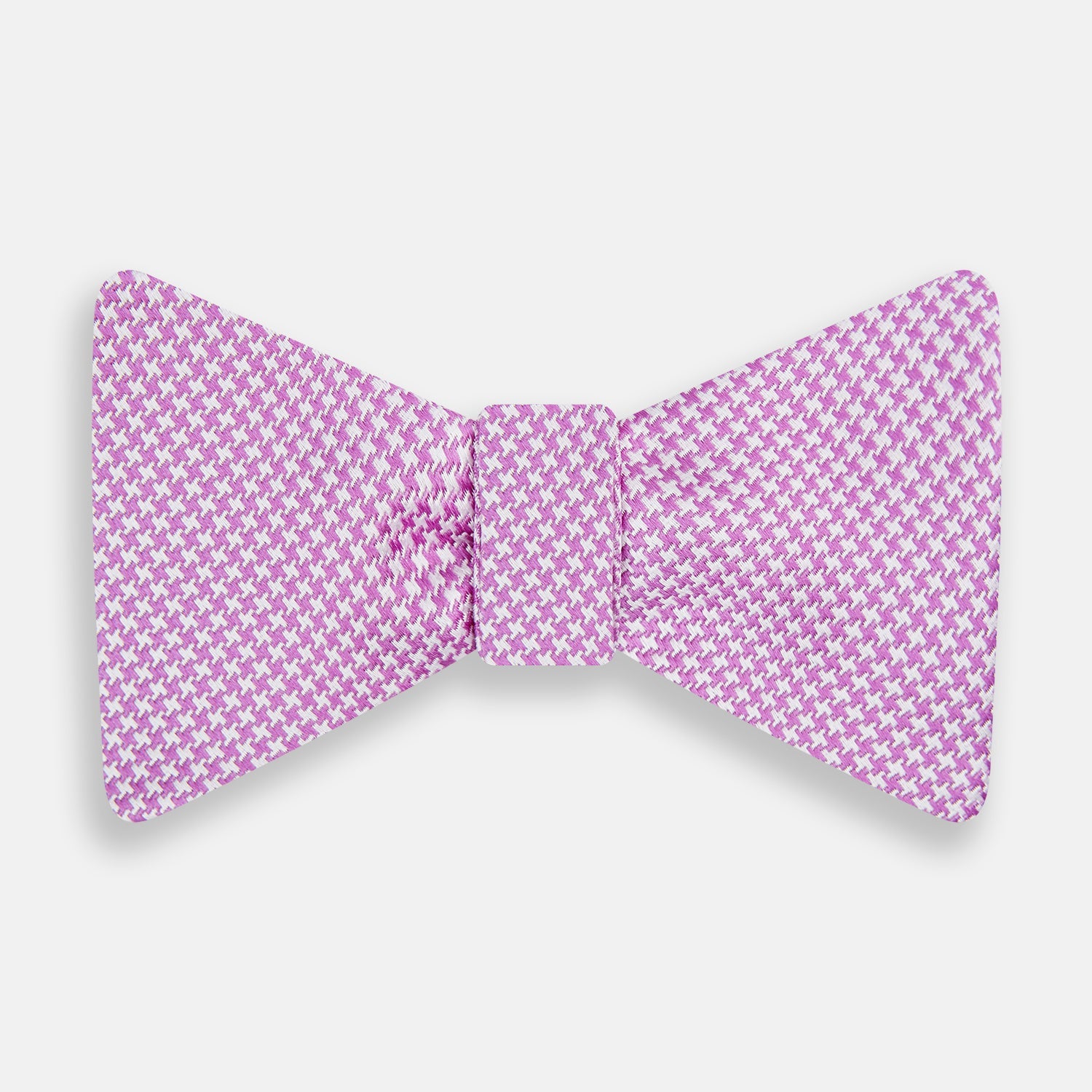 View 1 of product The Turnbull & Asser Pink and White Houndstooth Silk Bow Tie is shown against a plain white background, making it a stylish choice for formalwear.